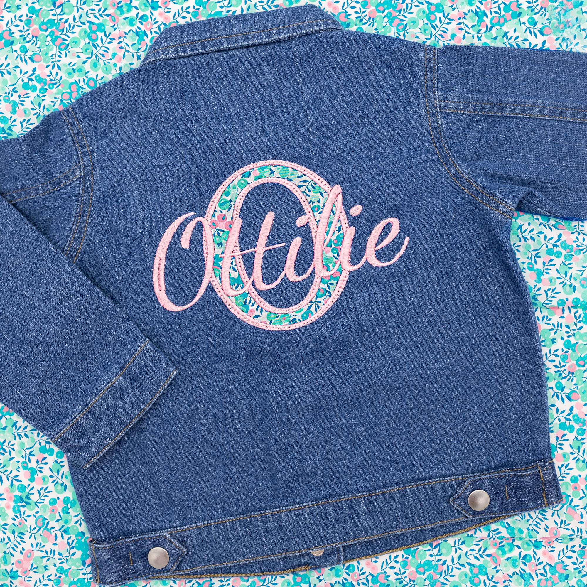 Childs personalised denim jacked with name embroidered over liberty of London appliqué