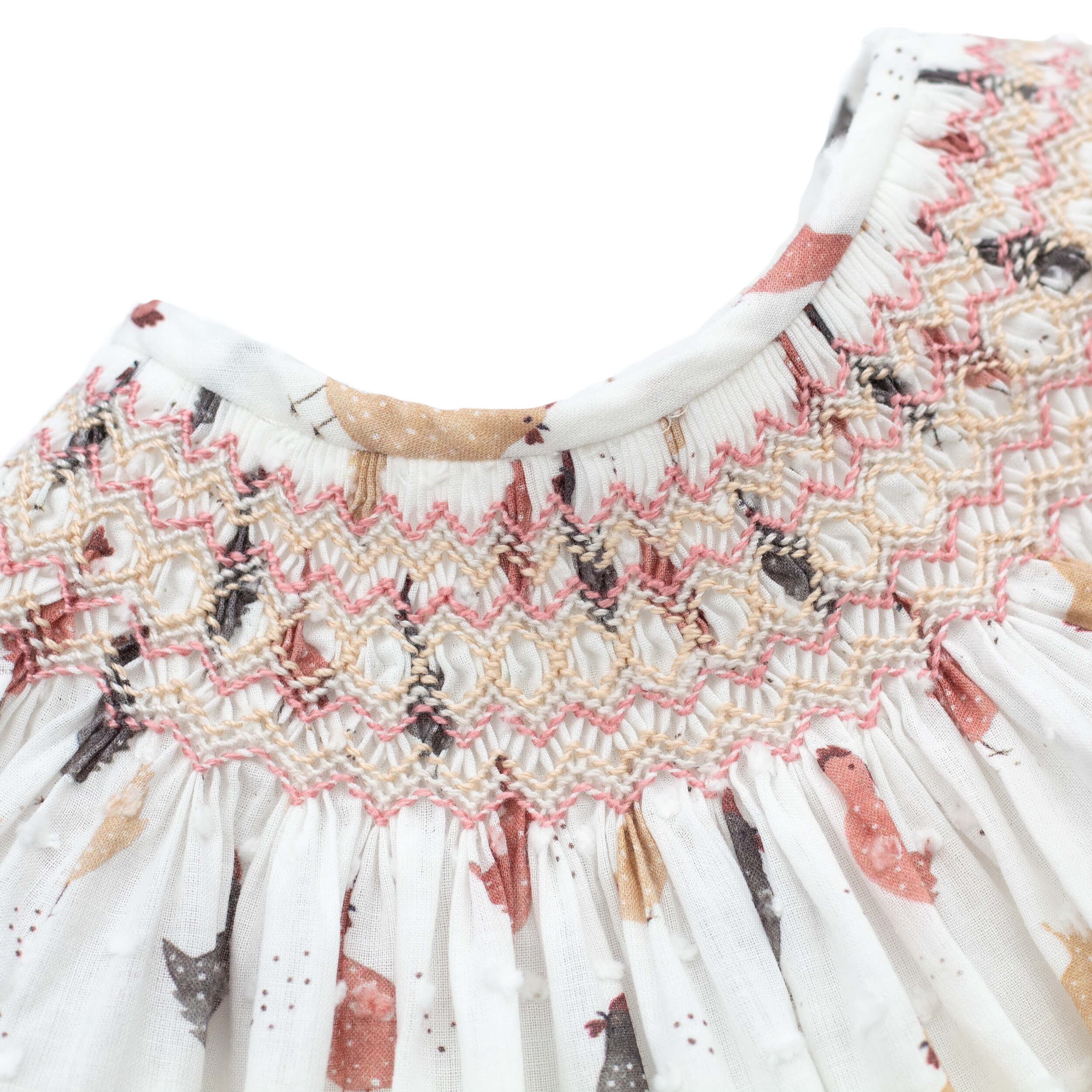 close up of hand smocking on spanish smocked baby dress