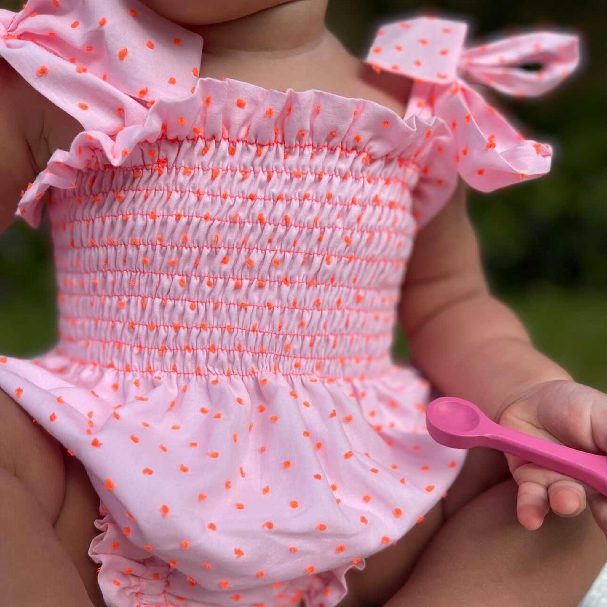 baby wearing neon pink plumeti baby girl romper
