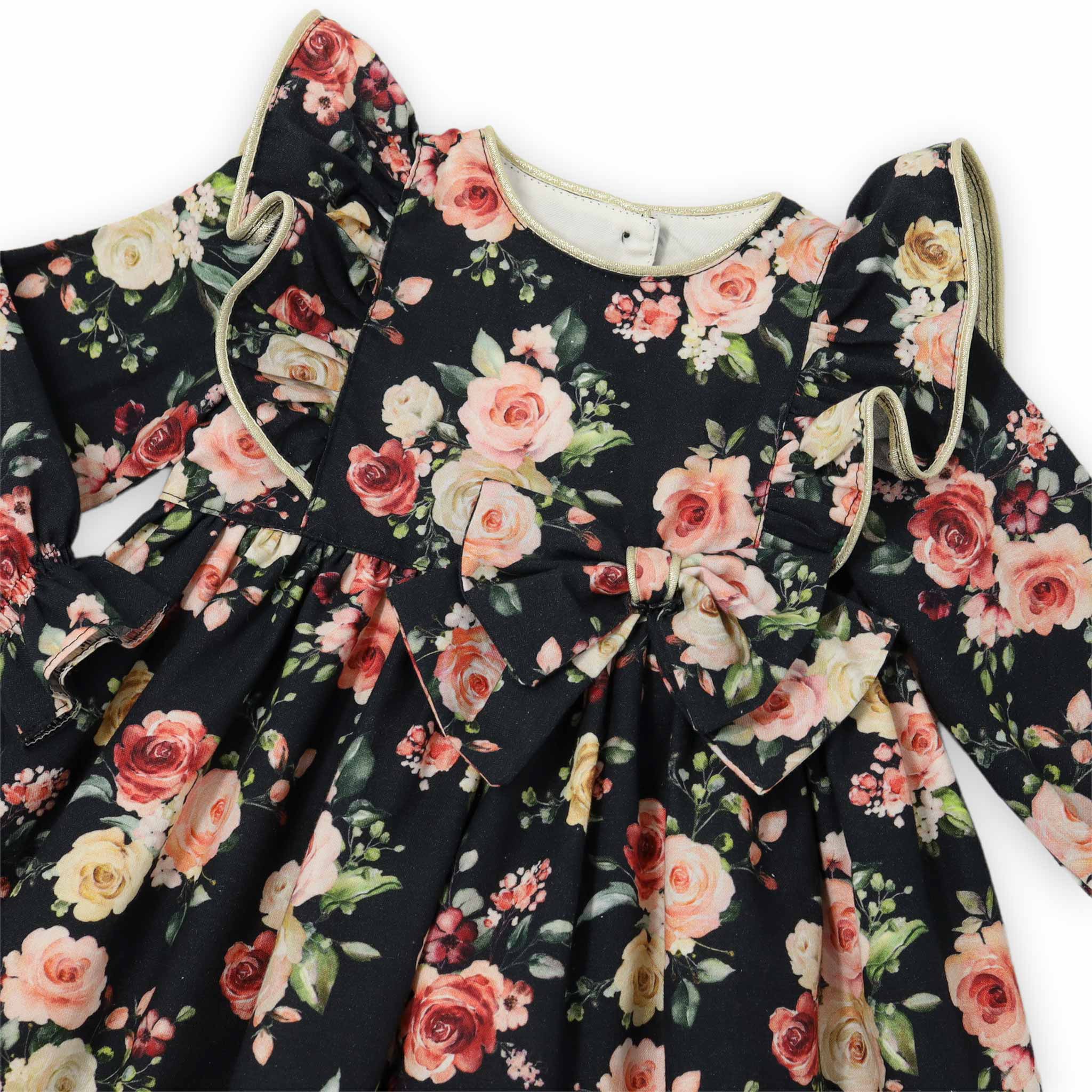 close up of bow on black floral girls dress