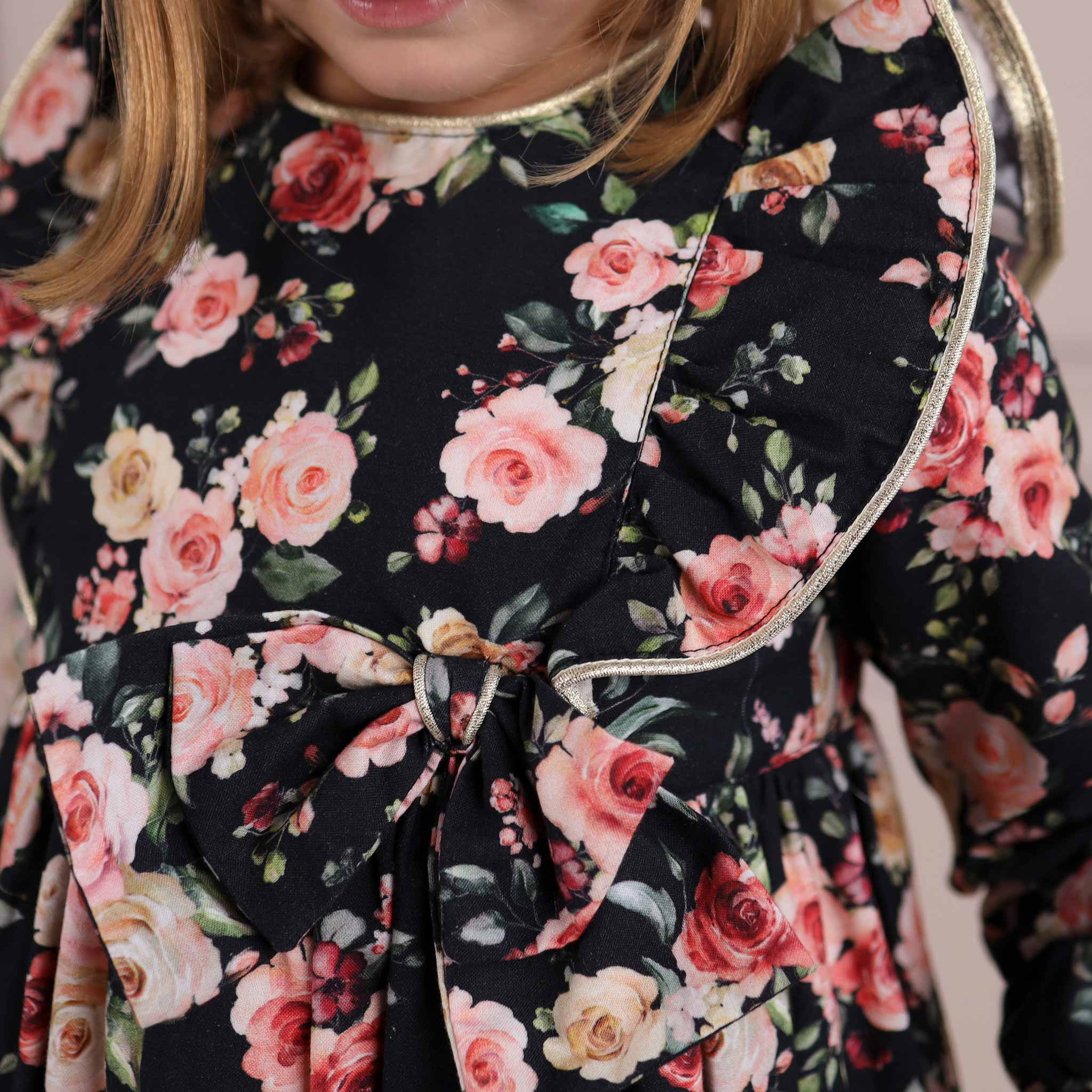 close up of detail on black floral girls dress