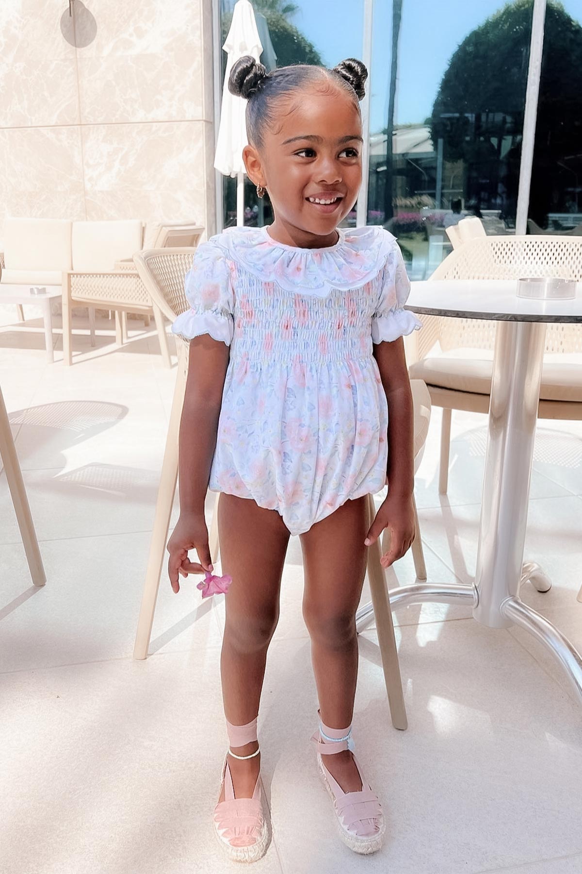 girl wearing blue floral romper