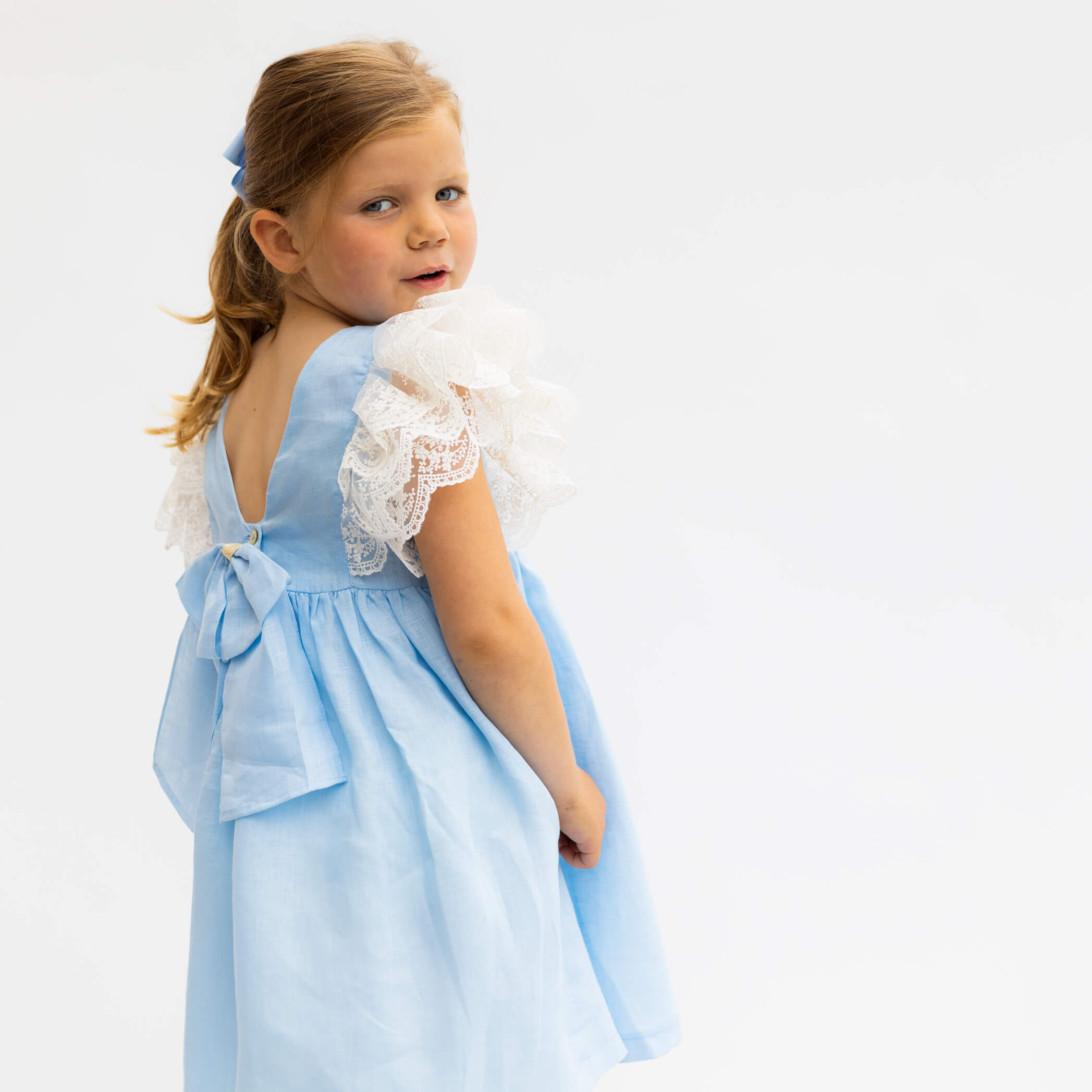 blue linen dress with lace shoulders and bow back