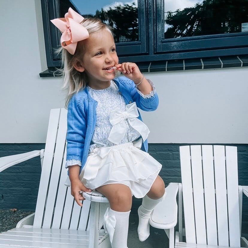 girl wearing floral girl blouse and ruffle bloomers