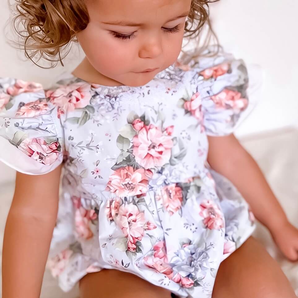 baby girl wearing floral blue romper