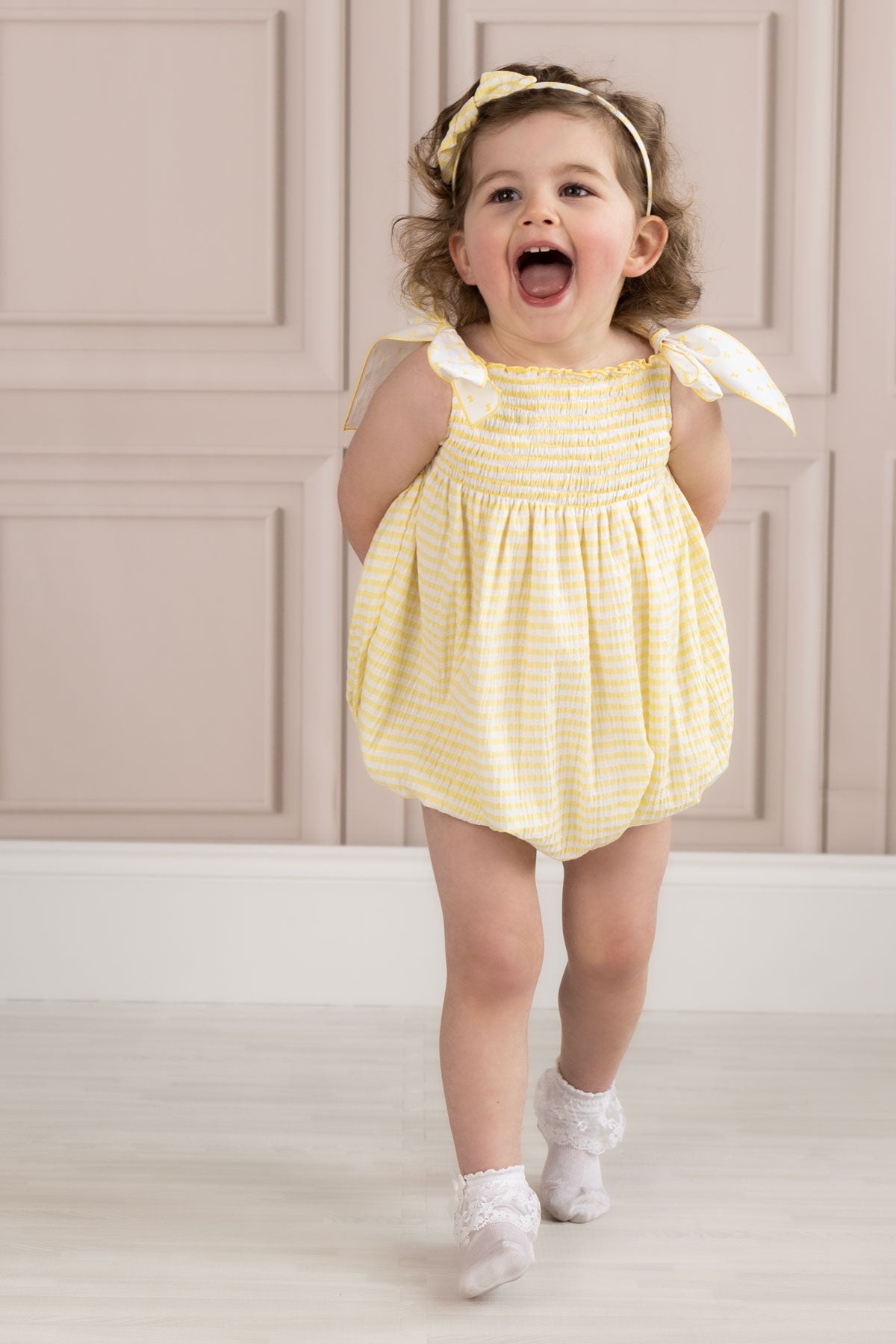 toddler wearing lemon seersucker girls romper