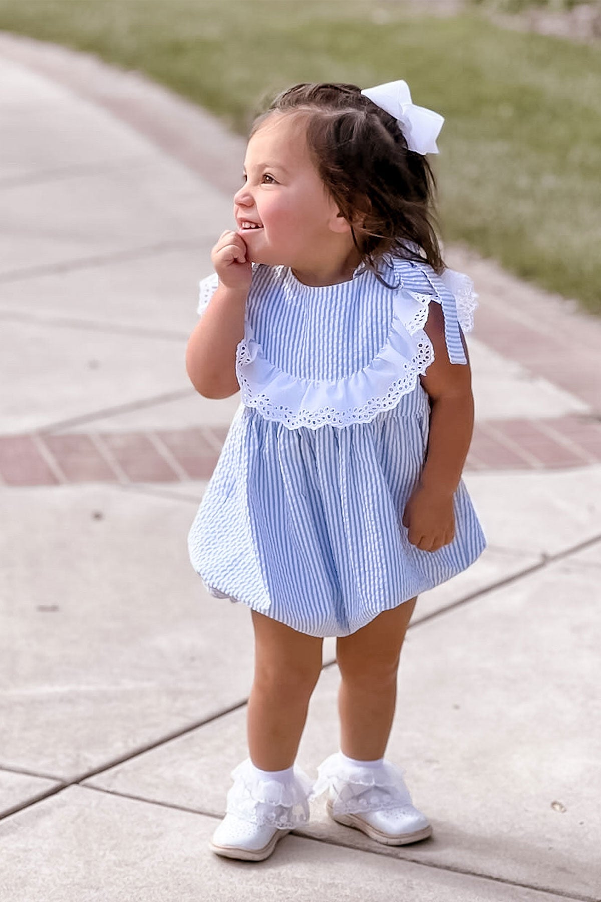 girl wearing seersucker romper