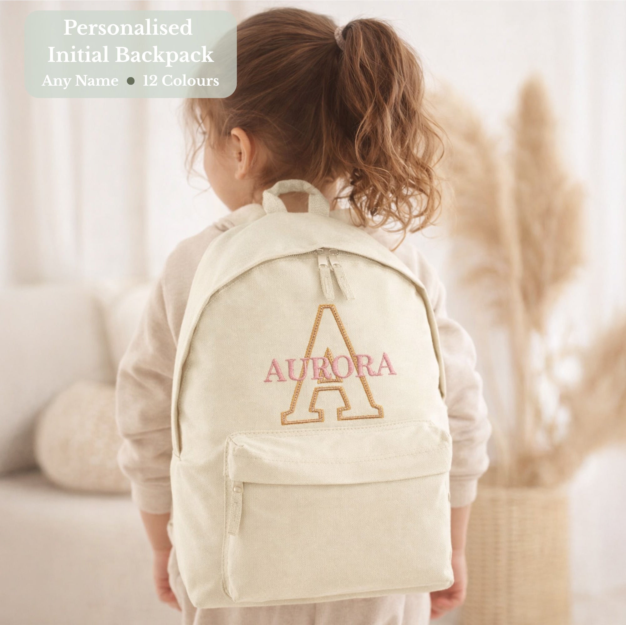 girl wearing personalised cream backpack