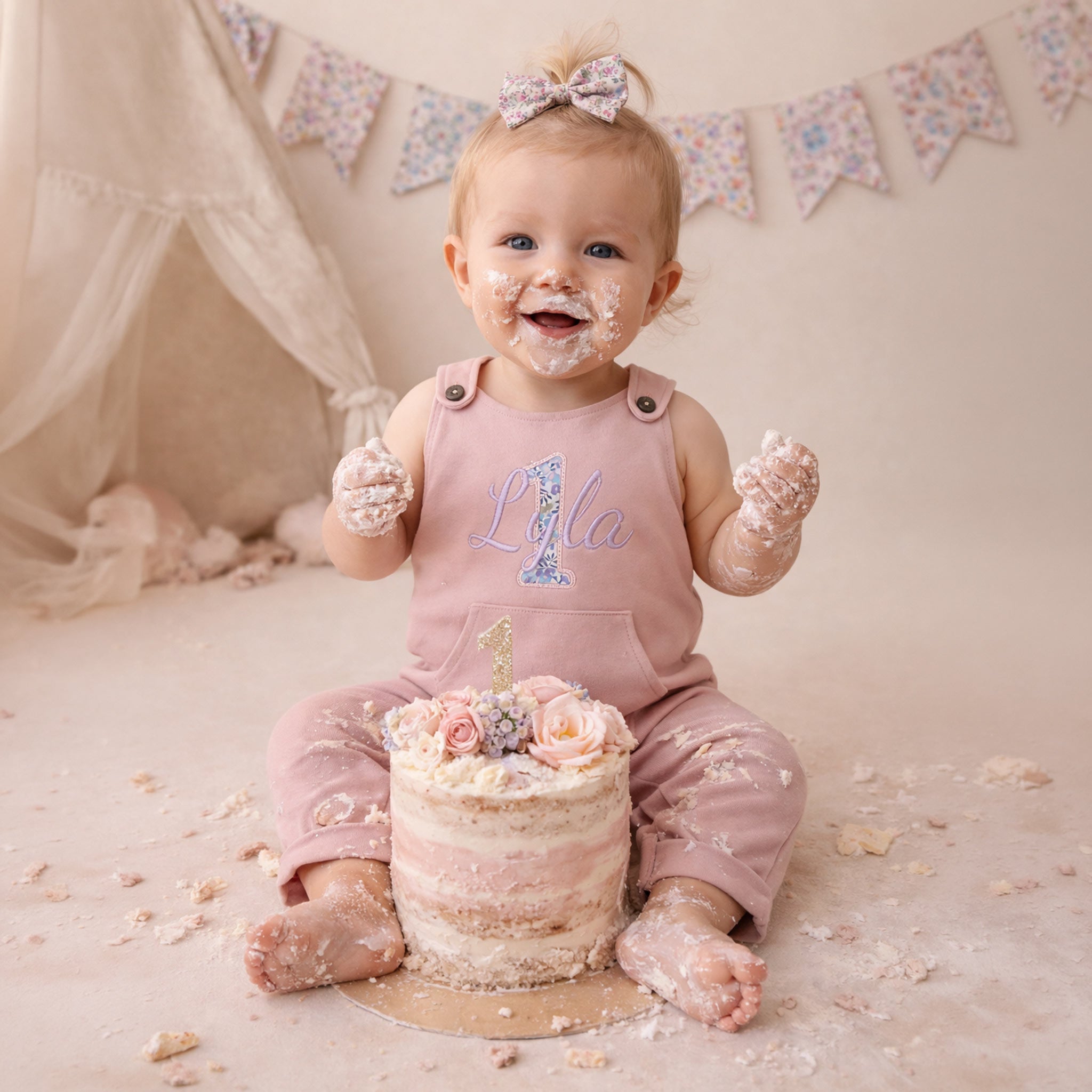 baby wearing personalised liberty birthday dungarees cake smash outfit