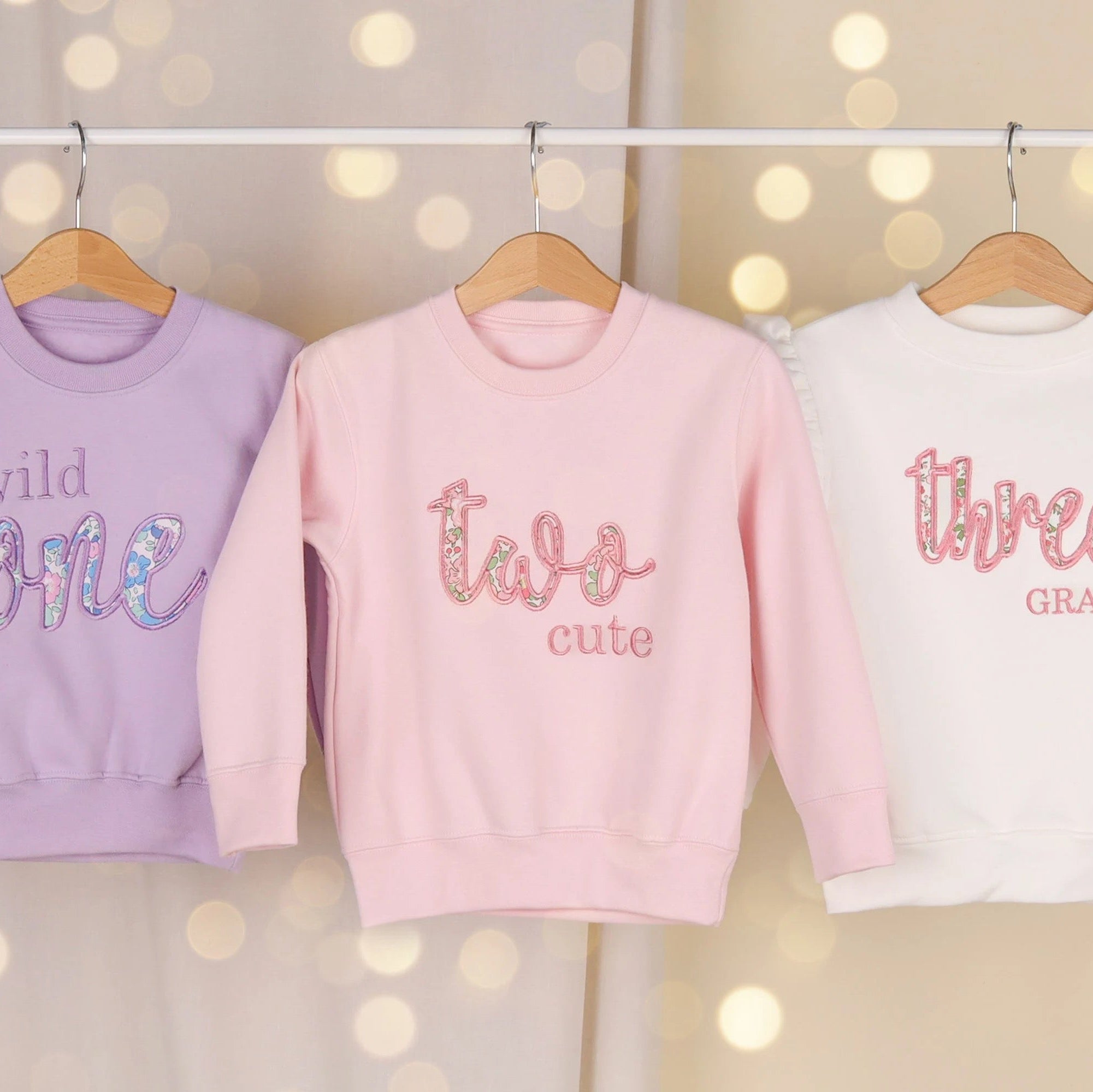 wild one, two cute and three applique birthday jumpers in lilac, pink and white featuring liberty of London fabric