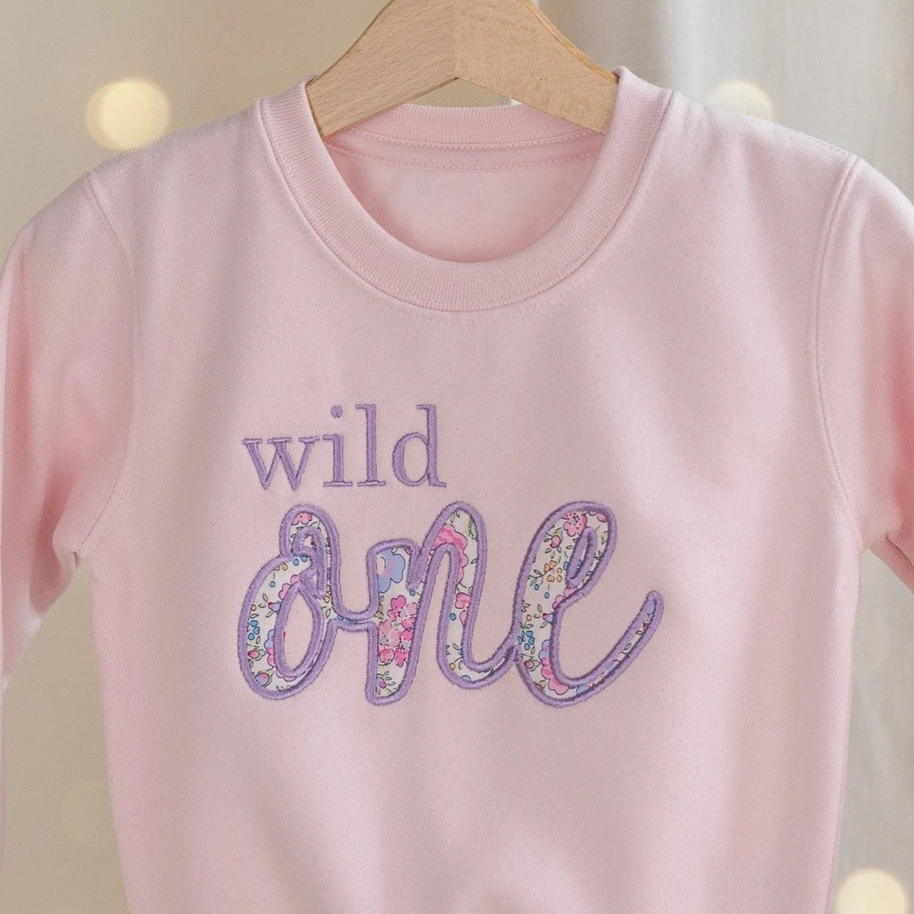Personalised Wild One first birthday sweatshirt for girls UK – back/side view showing soft cotton fabric and premium Liberty of London applique