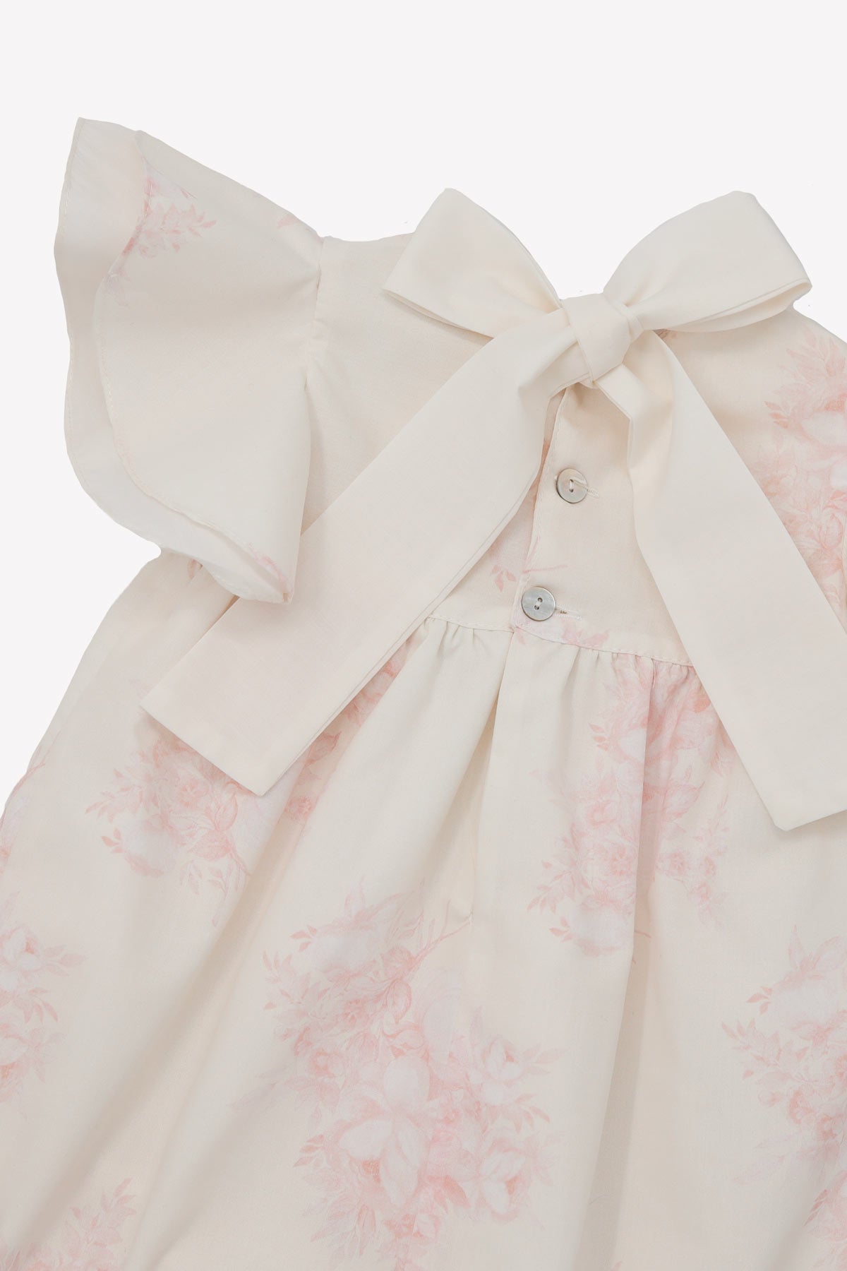 back of ivory baby girl romper with tie bow