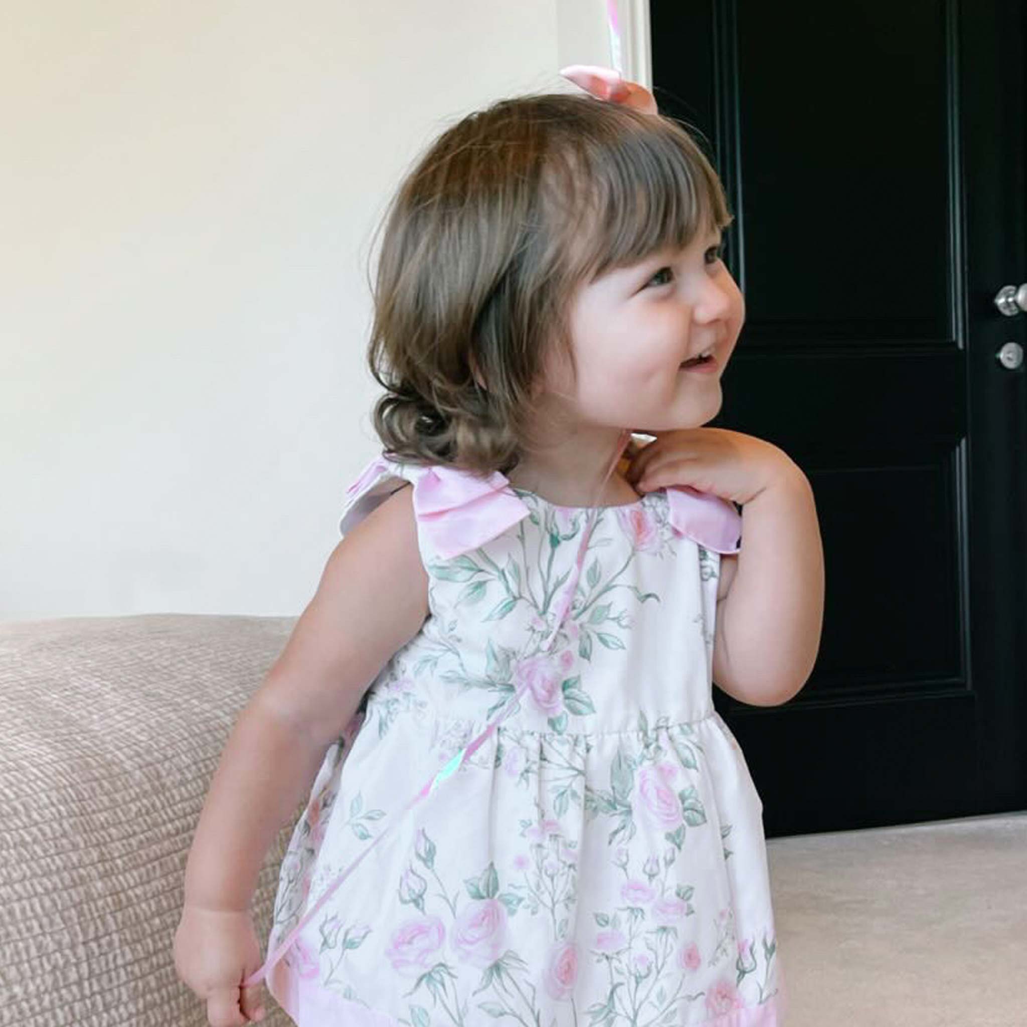 baby girl wearing pink floral blouse