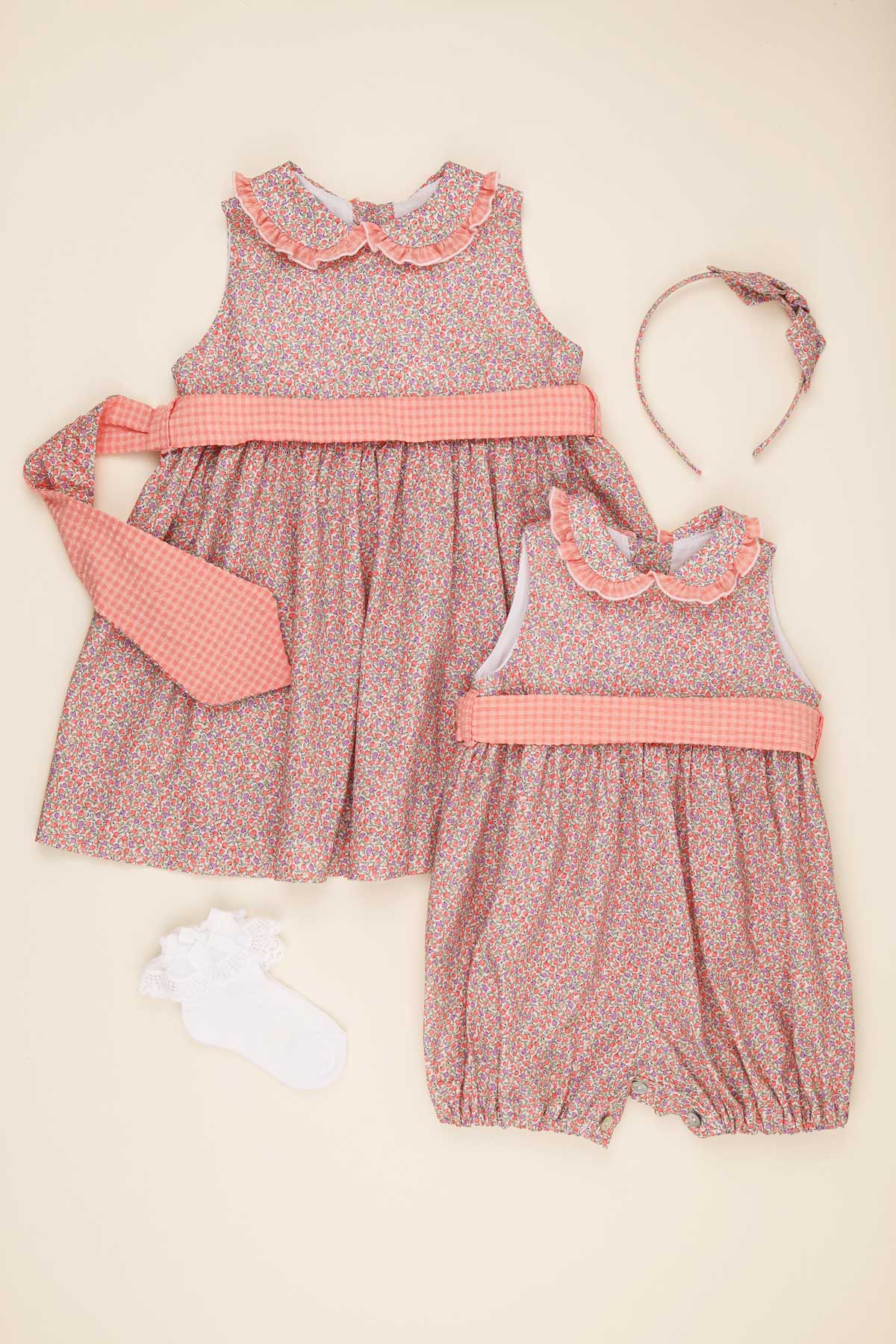 ditsy floral coral baby girl romper & girls dress flatlay